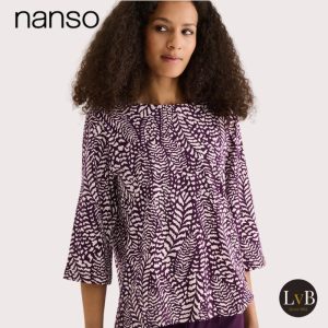 Model draagt het bovenstuk van de Nanso Fiona pyjama in lilac met driekwart mouwen en all-over print.